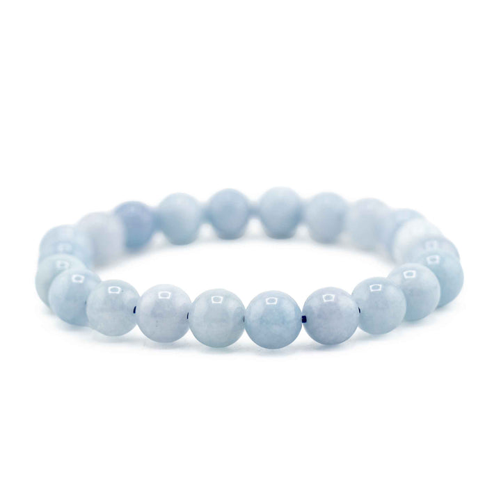 Side view resting shot of an Ocean Blue Aquamarine gemstone beaded bracelet resting flat on a white background