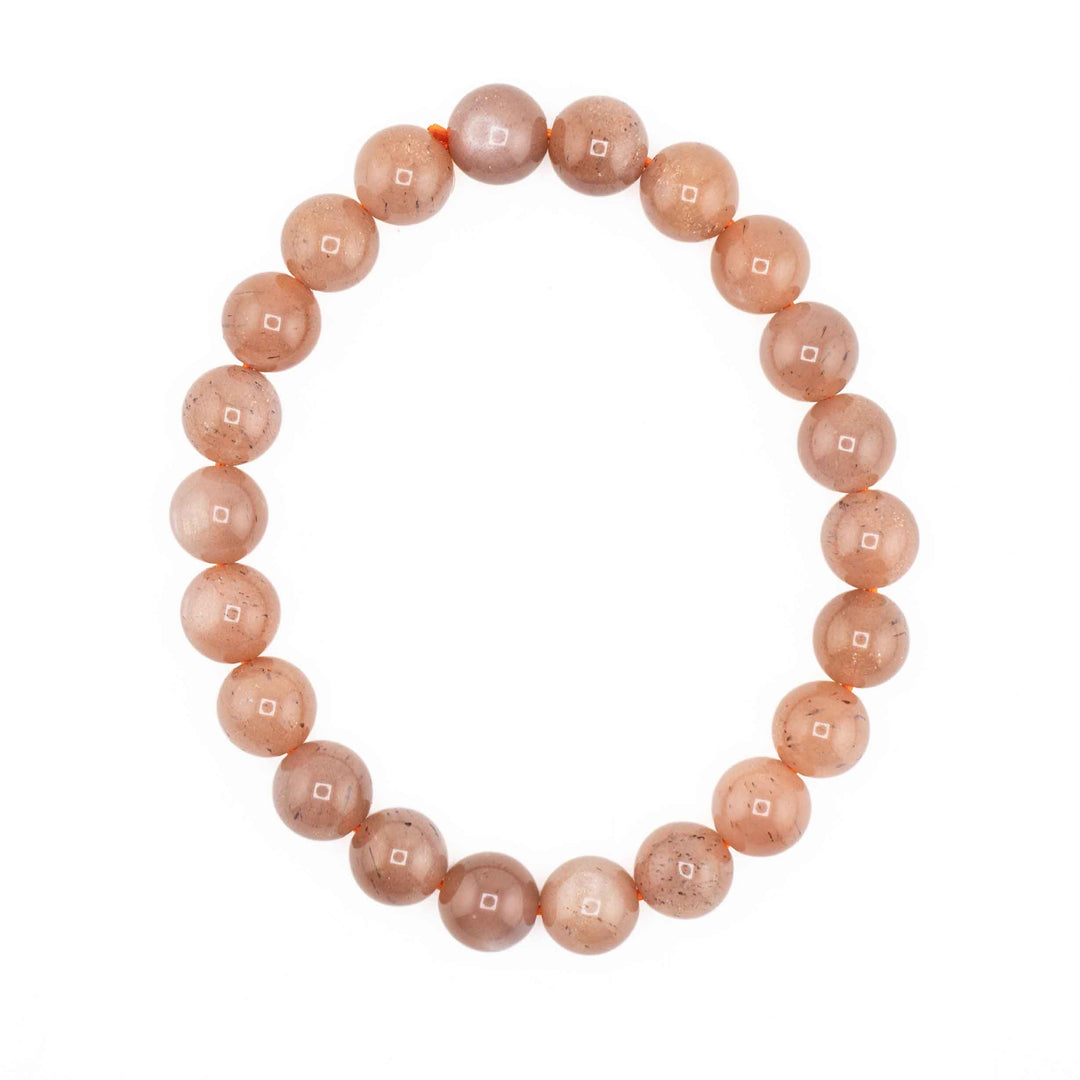 Natural Peach Moonstone beaded stretch bracelet featuring smooth, round peach-orange gemstone spheres on a white background