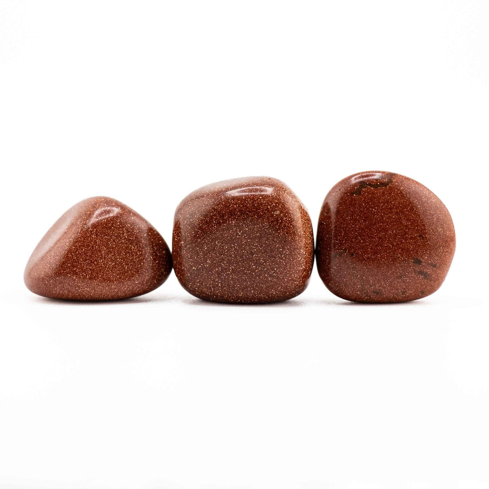 Row of three polished Red Goldstone tumbled stones displaying various natural shapes and sparkling reddish-gold finishes