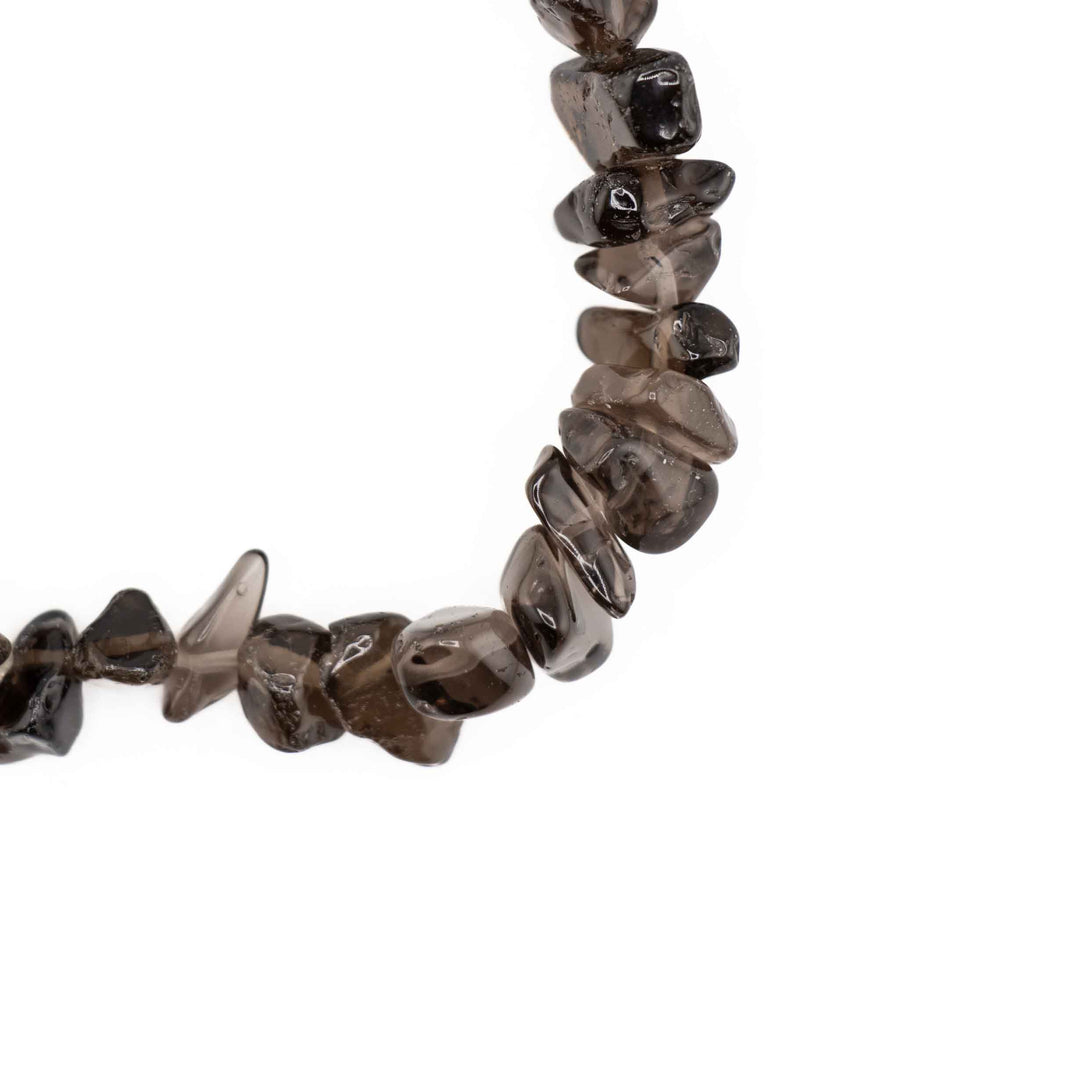 Close-up detail of polished Smoky Quartz tumbled chips showing natural translucency and deep smoky brown tones