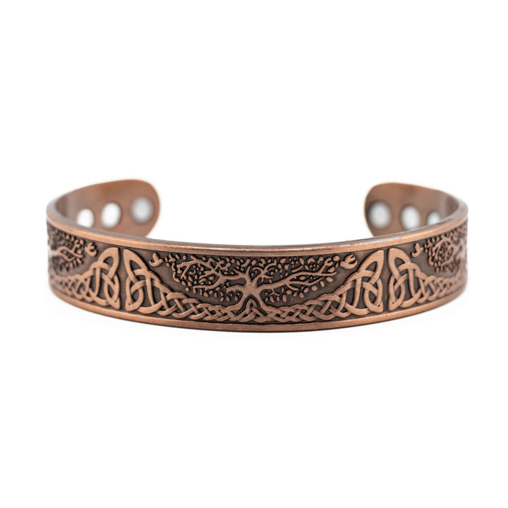 Copper bracelet with intricate designs on a white background