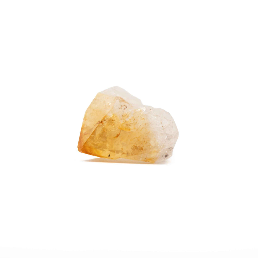 A raw, unpolished crystal specimen with a translucent yellow-orange section and a milky white section, set against a plain white background.