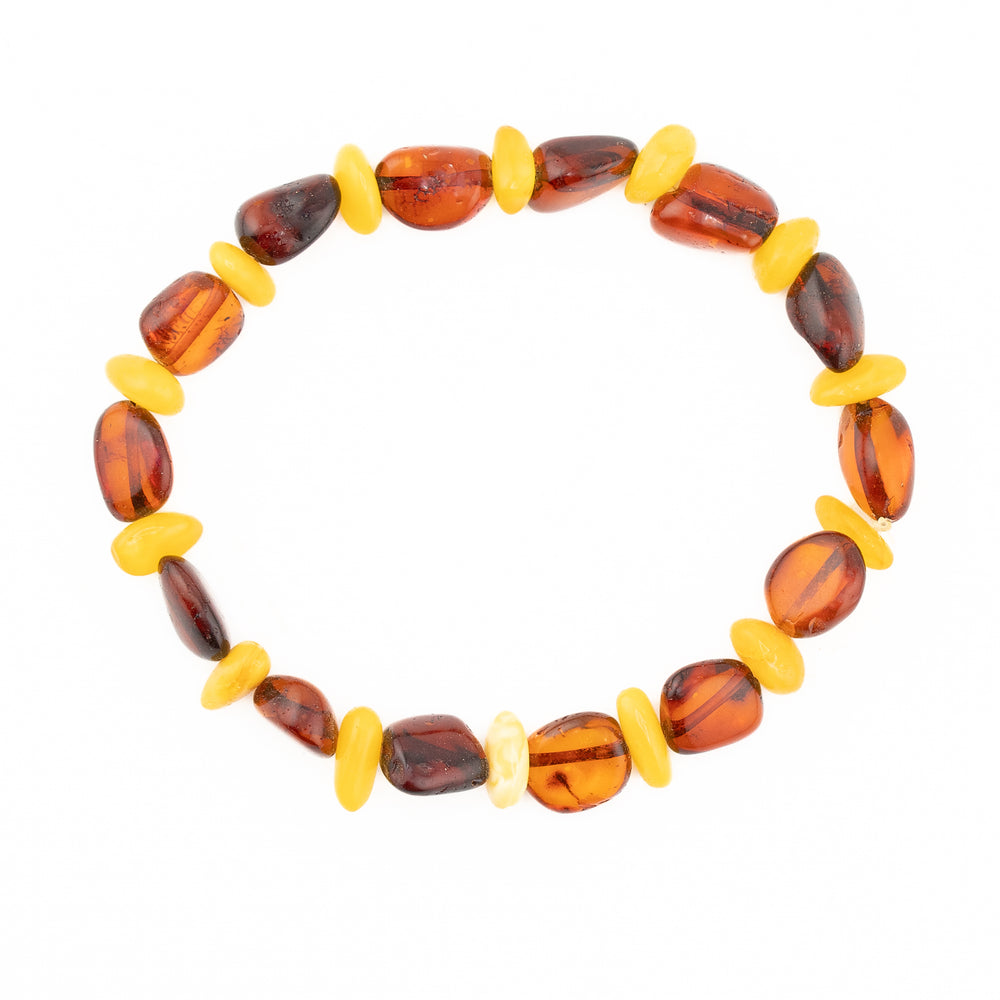 Handmade amber bead bracelet with alternating irregular tumbled polished beads of translucent rich cognac and opaque creamy butterscotch amber on a clean white background