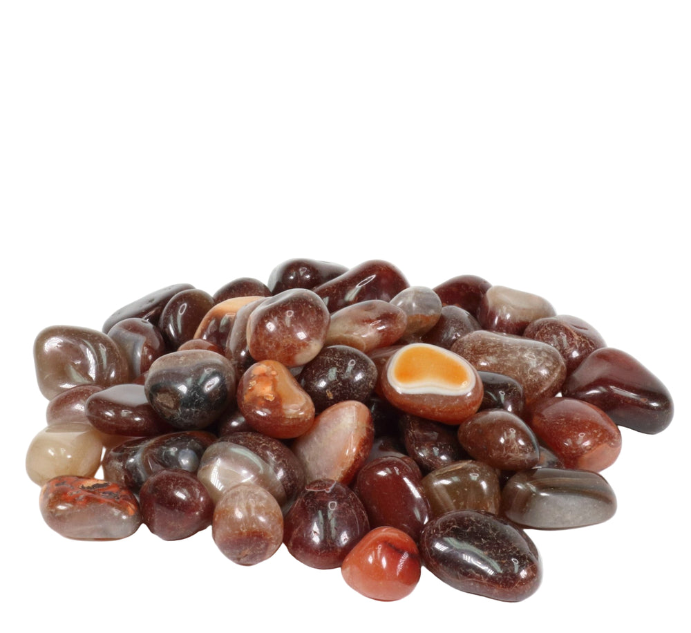 Photograph of a mound of polished reddish-brown and grey tumbled agate stones, including one with a distinct orange eye pattern and white banding