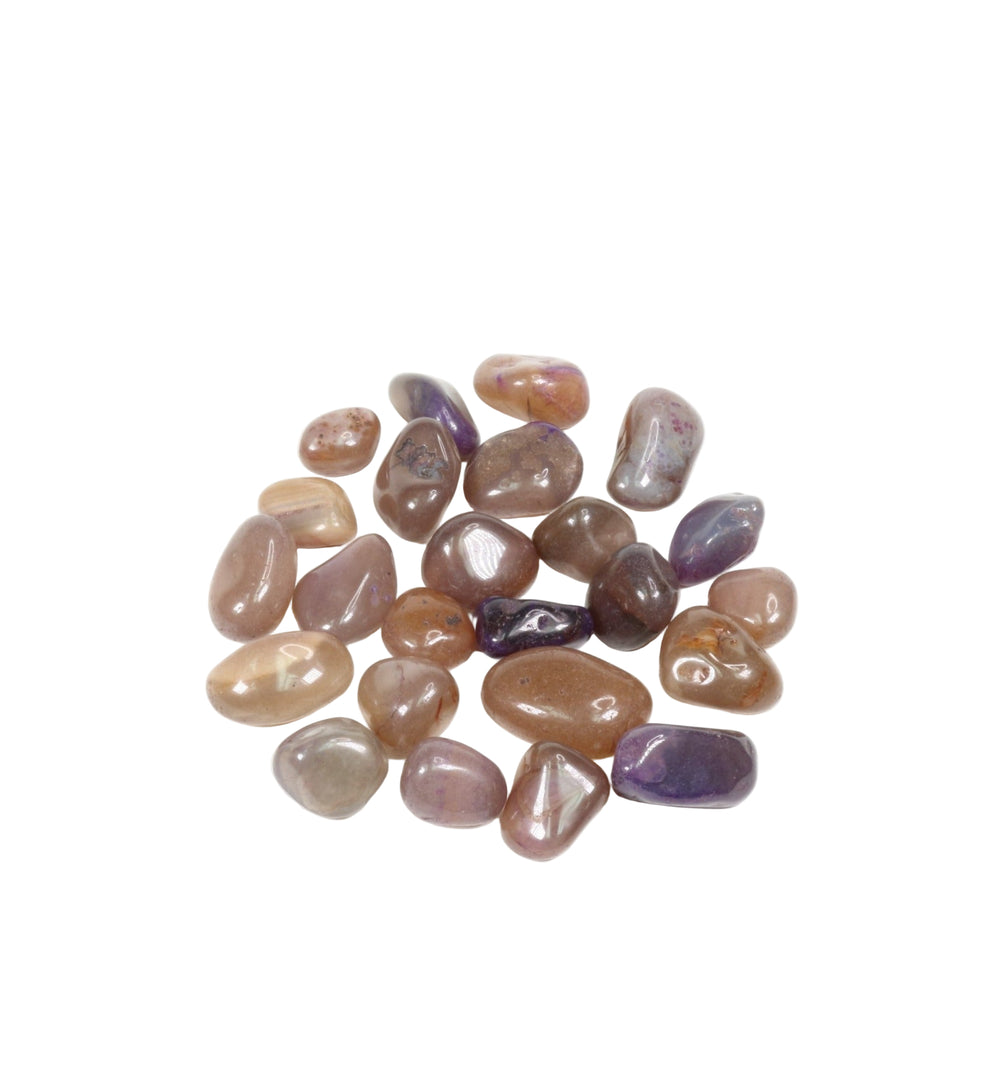 Photograph of a scattered pile of smooth, polished moonstone and sunstone crystals displaying peachy, brown, and purplish hues with a subtle shimmer